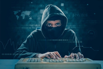 Hacker with mask attacking a system