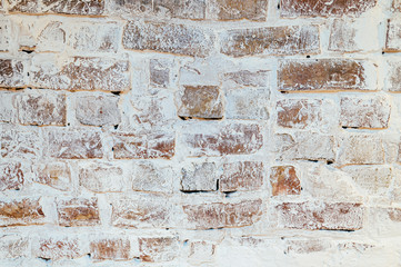 Old brick wall painted in white in the apartment.