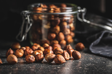 Peeled hazelnuts on old kitchen table.