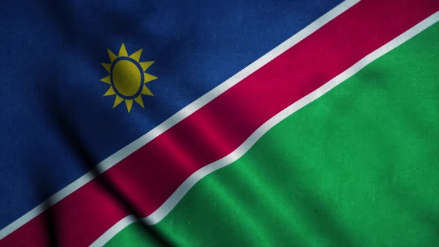 Namibia flag waving in the wind. National flag of Namibia. Sign of Namibia seamless loop animation. 4K