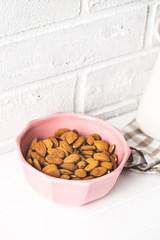 Dried almonds nuts in bowl.