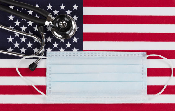 Medical stethoscope and mask with United States flag as background