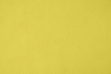 Saturated yellow colored low contrast Concrete textured background with roughness and irregularities. 2020, 2021 color trend.
