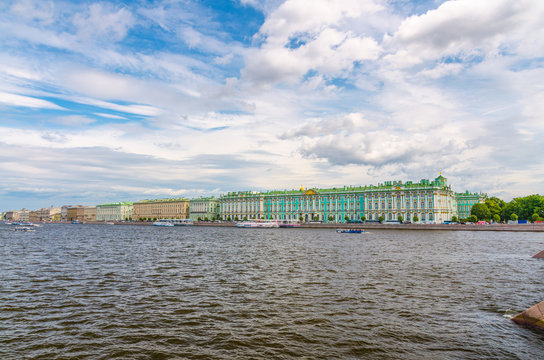 The State Hermitage Museum building, The Winter Palace official residence of the Russian Emperors on embankment of Neva river, blue sky white clouds, Saint Petersburg Leningrad city, Russia