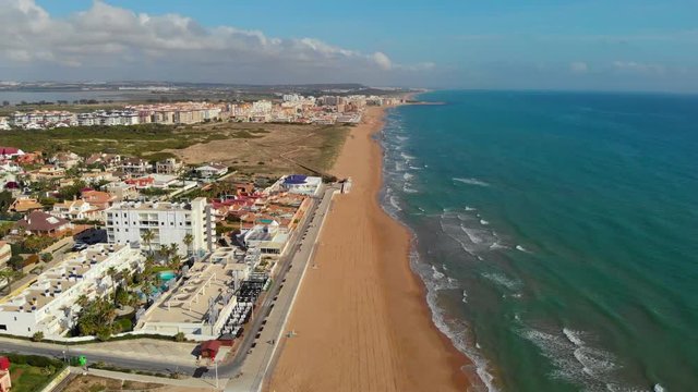 Aerial view empty beach of La Mata during quarantine. Public places closed caused by pandemic disease situation. Quarantine globally spread infection. Stop COVID-19. Torrevieja, Costa Blanca, Spain