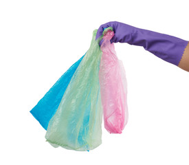 hand holds an empty green plastic bag on a white background, concept of rejection