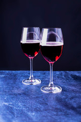 Romantic holiday, glasses with red wine, dark background