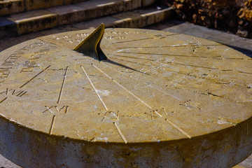 Old stone sundial with a shadow - obrazy, fototapety, plakaty