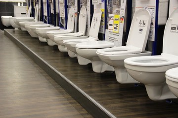 toilets and bidets in the window of a large hypermarket of goods for construction and repair....