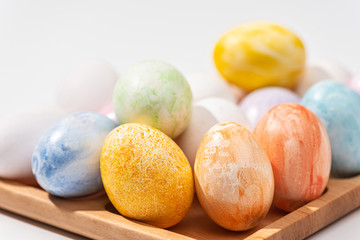 Happy Easter! Beautiful colorful Easter eggs on a wooden stand. Close-up.
