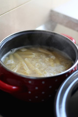 Cooking pasta in boiling water. Selective focus.