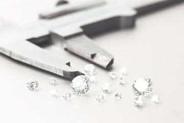 Macro close up of experienced goldsmith sorting high quality diamonds, selecting them to make precious jewels in workshop.Concept of jewelry,luxury,goldsmith, diamonds, brilliance.