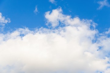 Beautiful white big soft fluffy cloud on a clear blue sky background