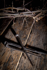 Bloody nails and crown of thorns as symbol of passion of Jesus Christ.