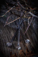 Close up crown of thorns and nails again vintage wooden background as symbol of crucifixion of...
