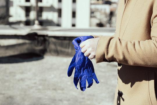 Man putting on medical gloves for protection from Coronavirus