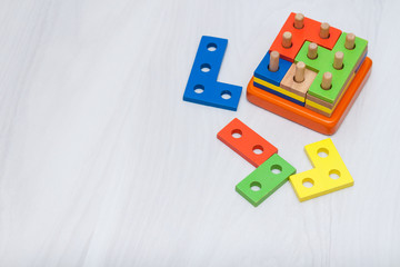 Colorful wooden toys for logical thinking, education. Copy space, top view. Logic game concept.