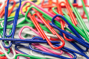 Stationery plastic multicolored paper clips. Macro photography