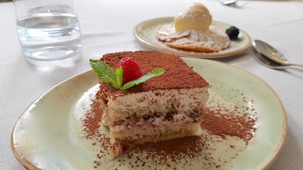 Tiramisu plate with mint leaf and raspberry