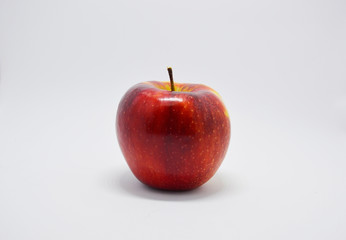 red, bold  juicy apple on a white background. apple is a source of vitamins and iron