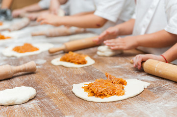 Young children make dough products. Hands closeup