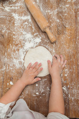 Young children make dough products. Hands closeup