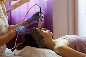 Beautiful woman in spa salon getting face treatment