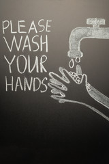 Drawing of a hand wash on the blackboard with chalk and the inscription -Please wash your hands....