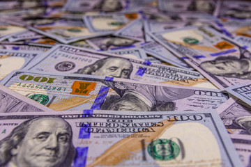 Background of one hundred dollar banknotes. Selective focus