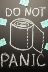 Drawn toilet paper roll on the blackboard with chalk and the inscription-DO NOT PANIC! Panic, coronavirus