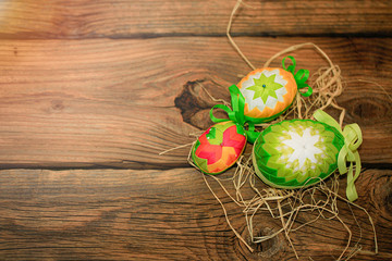 Easter eggs hand made on the wood backround.