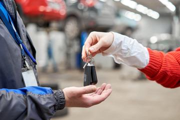 Rusty drum brakes, rear on red car. Change the old to new brake disc on car in a garage. Auto...