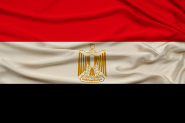 photo of the national flag of the state of Egypt on a luxury texture of satin, silk with waves,...