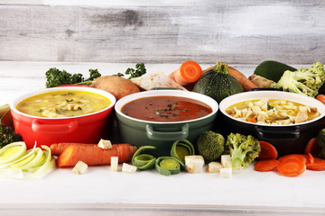 Set of soups from worldwide cuisines, healthy food. Broth with noodles, beef soup and broth with marrow dumplings. All soups with healthy vegetables on table