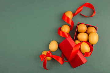 Eggs festively decorated lie on a simple background with place for text, top view, concept of...