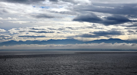 Thunderclouds and rain clouds over the coastline of the Strait of Juan de Fuca. Pacific Ocean.