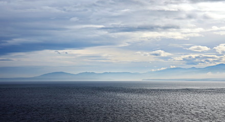 Thunderclouds and rain clouds over the coastline of the Strait of Juan de Fuca. Pacific Ocean.