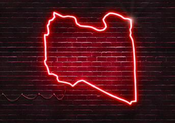 Neon sign on a brick wall in the shape of Libya.(illustration series)