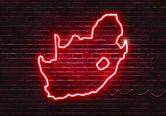 Neon sign on a brick wall in the shape of South Africa.(illustration series)