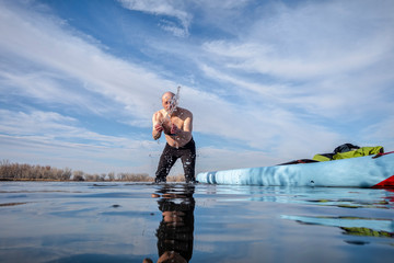 senior male with stand up paddleboard