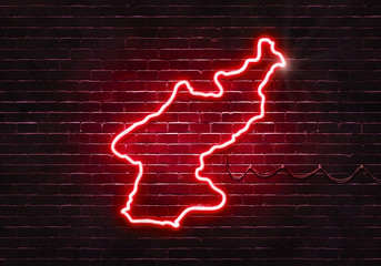 Neon sign on a brick wall in the shape of North Korea.(illustration series)