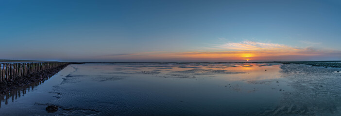  An impressive panorama view of the dike foreland near the imposing Eider barrage, Sunset over the...