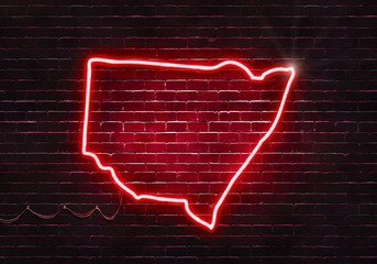 Neon sign on a brick wall in the shape of New South Wales.(illustration series)