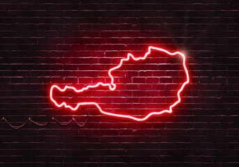 Neon sign on a brick wall in the shape of Austria.(illustration series)
