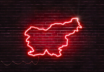 Neon sign on a brick wall in the shape of Slovenia.(illustration series)