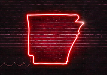 Neon sign on a brick wall in the shape of Arkansas.(illustration series)