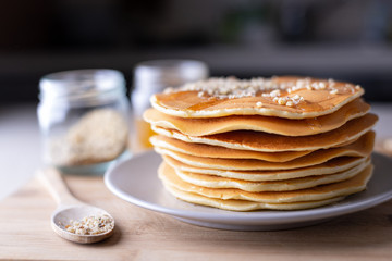 Young female chef in kitchen at home preparing american pancakes. Healthy eating