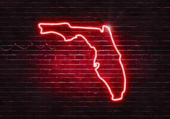 Neon sign on a brick wall in the shape of Florida.(illustration series)