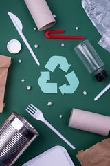 Reuse reduce recycle flat lay concept with plastic, paper, and polyethylene waste. Ecology...