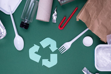 Reuse reduce recycle flat lay concept with plastic, paper, and polyethylene waste. Ecology...